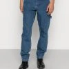 Blitzangebot 😀 Karl Kani RETRO WORKWEAR - Jeans Tapered Fit - Dark Indigo, Herren 😉 -Karl Kani Verkäufe 20a42ab2304348a584a2a89b87078b26