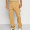 Coupon ⌛ Karl Kani RETRO PANTS UNISEX - Stoffhose - Sand 🥰 -Karl Kani Verkäufe 308a22134f674cf896d72aafcc61191d