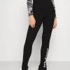 Top 10 🧨 Karl Kani RETRO SLIT - Leggings - Hosen - Black, Damen 🥰